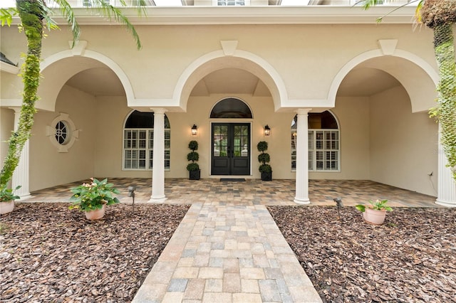 doorway to property with french doors and stucco siding