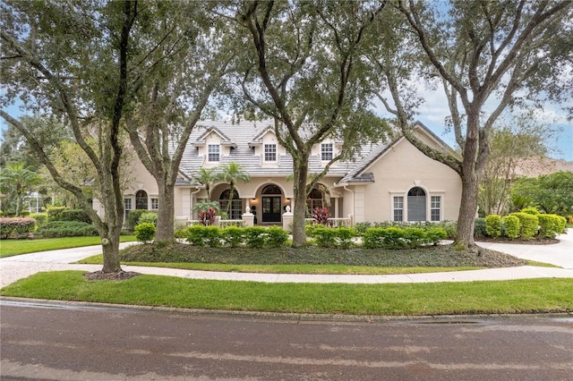 view of front of home with a tiled roof and stucco siding