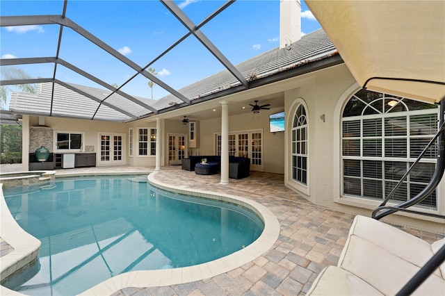 view of swimming pool featuring a ceiling fan, french doors, a patio area, and a lanai