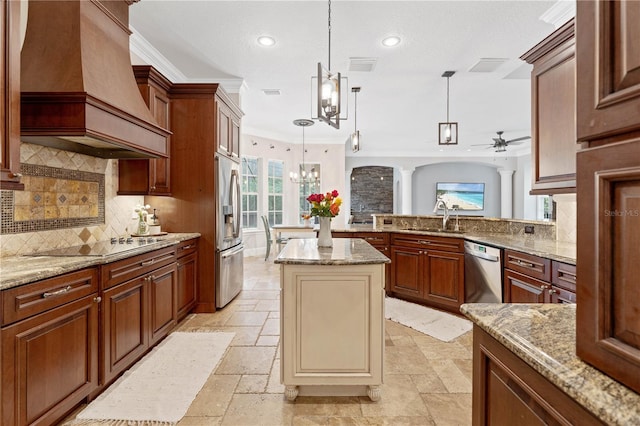 kitchen featuring decorative columns, stone tile floors, stainless steel appliances, custom range hood, and a sink