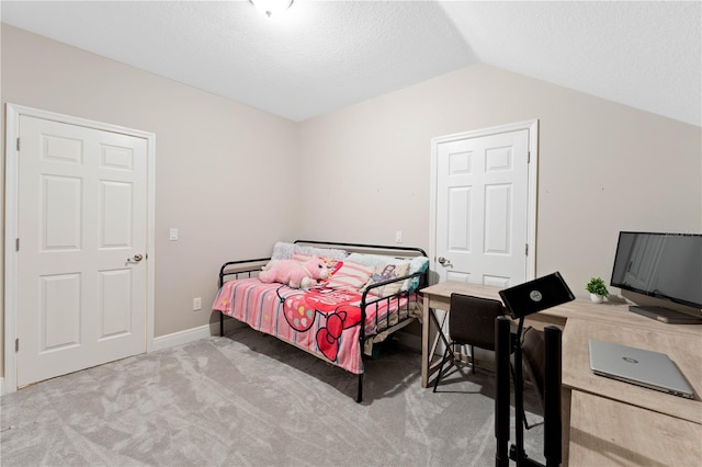 bedroom featuring light colored carpet, vaulted ceiling, a textured ceiling, and baseboards