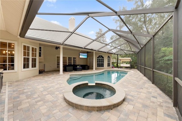 view of swimming pool with a pool with connected hot tub, a lanai, a patio, and ceiling fan