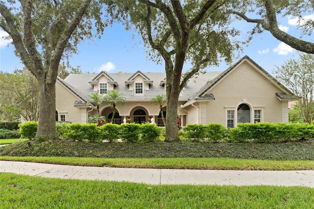 view of front of property with a tile roof and stucco siding