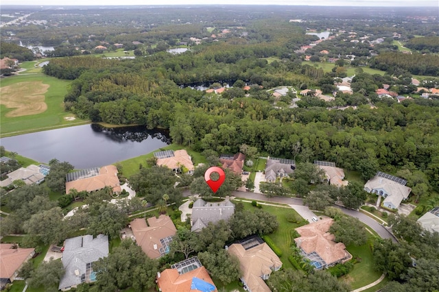 aerial view featuring a water view, a residential view, and a wooded view