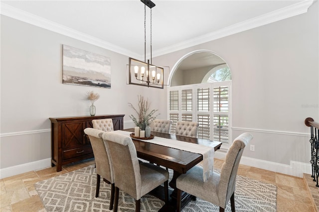 dining space featuring ornamental molding, stone tile flooring, and baseboards