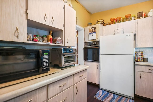 kitchen with black appliances and dark hardwood / wood-style floors