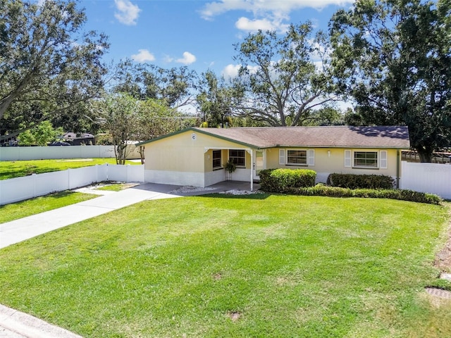 ranch-style home featuring a front yard