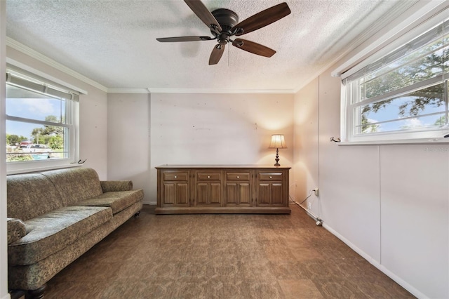 sitting room with ceiling fan, a textured ceiling, crown molding, and a wealth of natural light