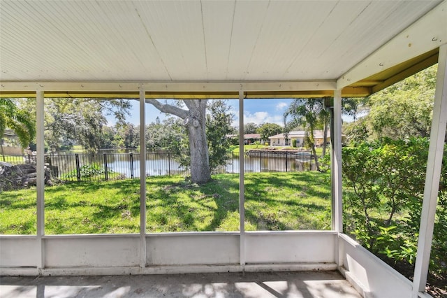 unfurnished sunroom with a water view