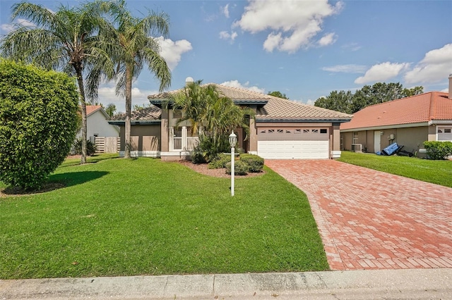 mediterranean / spanish-style house with a garage and a front yard