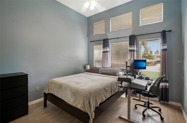 bedroom with ceiling fan and light hardwood / wood-style floors