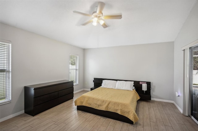 bedroom with ceiling fan, lofted ceiling, light hardwood / wood-style floors, and multiple windows