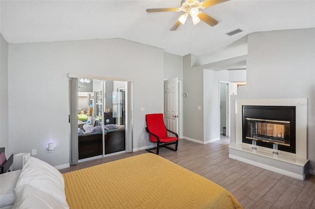 bedroom with ceiling fan, hardwood / wood-style flooring, and lofted ceiling