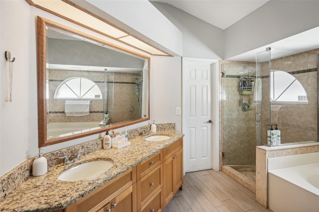 bathroom with independent shower and bath, vanity, and wood-type flooring