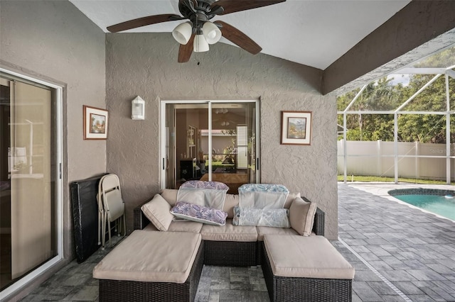 view of patio / terrace featuring glass enclosure, outdoor lounge area, ceiling fan, and a fenced in pool