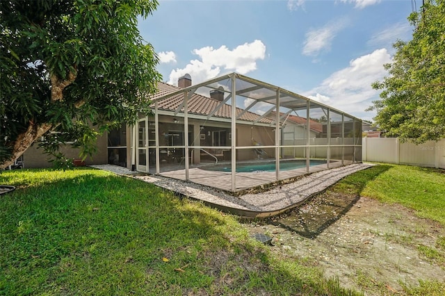 view of swimming pool with a yard, a lanai, and a patio area