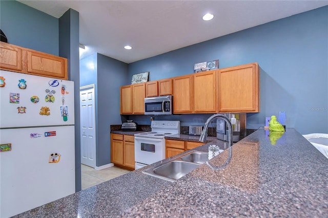 kitchen with sink, white appliances, kitchen peninsula, and light tile patterned flooring