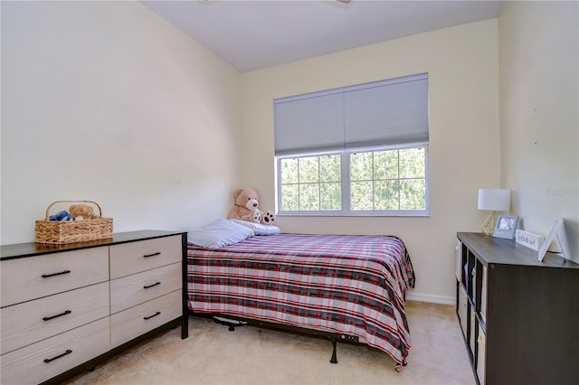 bedroom featuring light carpet