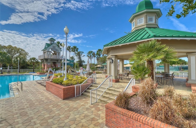 surrounding community with a swimming pool, a patio area, and a gazebo