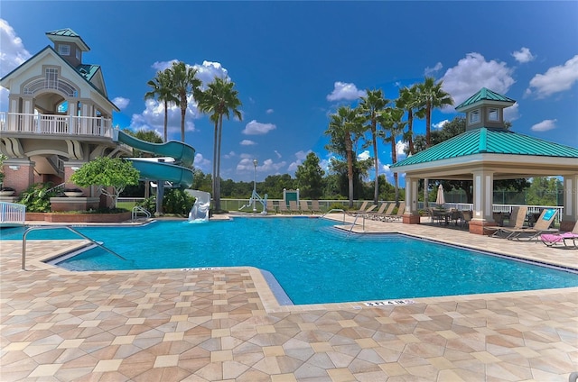 view of pool featuring a gazebo, a patio area, and a water slide