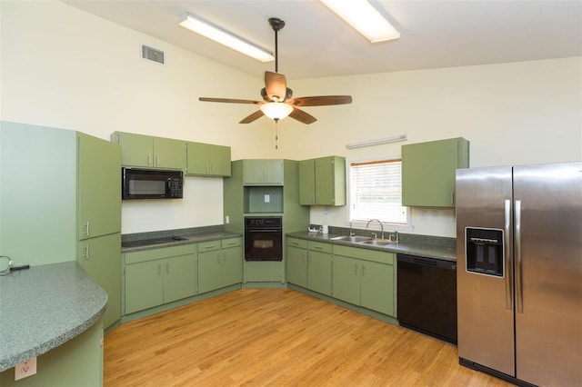 kitchen with ceiling fan, green cabinetry, light hardwood / wood-style flooring, and black appliances