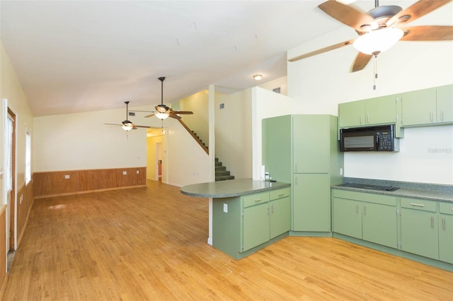 kitchen with green cabinets, light wood-type flooring, black appliances, and ceiling fan