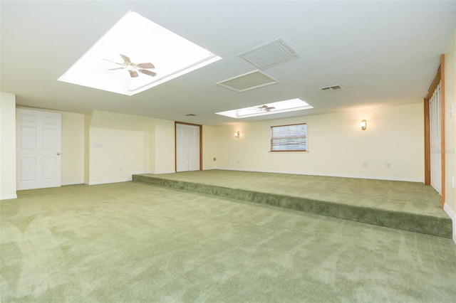 basement featuring carpet and ceiling fan