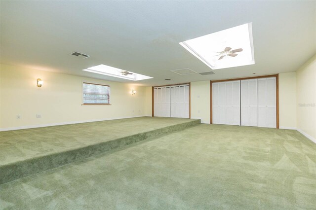 interior space featuring a skylight and carpet flooring