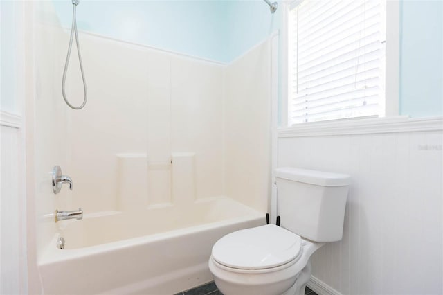 bathroom featuring tub / shower combination and toilet