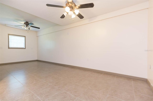 spare room featuring ceiling fan and light tile patterned floors