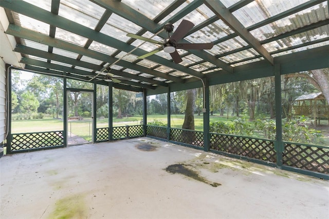 unfurnished sunroom featuring ceiling fan