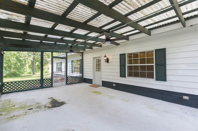 unfurnished sunroom featuring ceiling fan