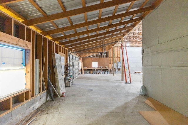 miscellaneous room with vaulted ceiling and concrete flooring