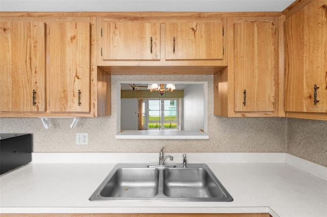 kitchen featuring a chandelier, sink, and decorative backsplash