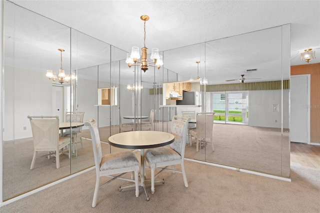 dining space with light carpet, ceiling fan, lofted ceiling, and a textured ceiling