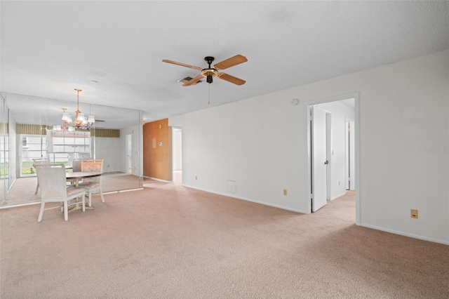 living room featuring ceiling fan with notable chandelier