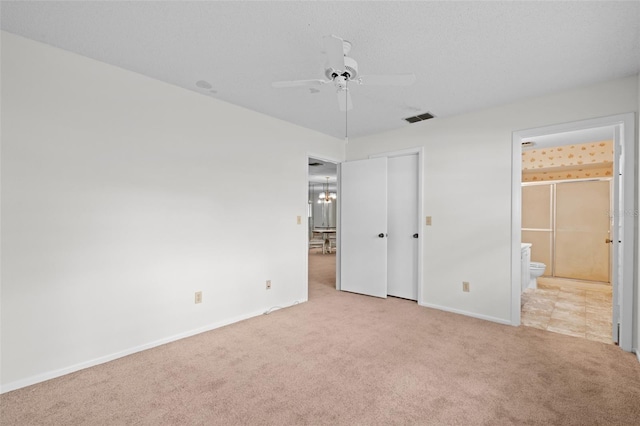 unfurnished bedroom featuring light carpet, connected bathroom, and ceiling fan