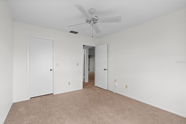 unfurnished bedroom featuring ceiling fan and light colored carpet