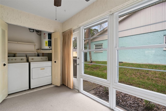 clothes washing area with light colored carpet, separate washer and dryer, and ceiling fan