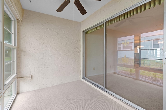 unfurnished sunroom with plenty of natural light and ceiling fan