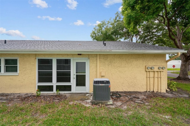 rear view of property featuring cooling unit