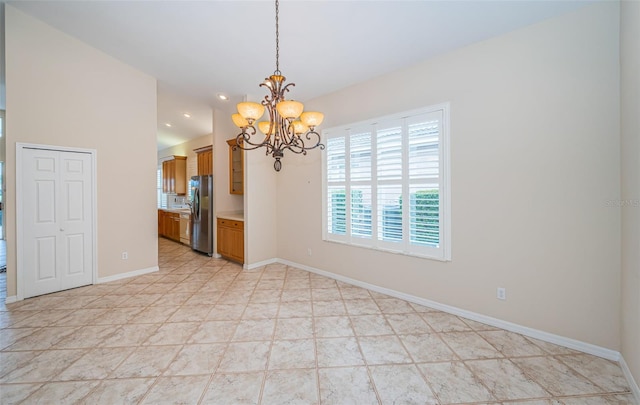 spare room featuring recessed lighting, baseboards, an inviting chandelier, and vaulted ceiling