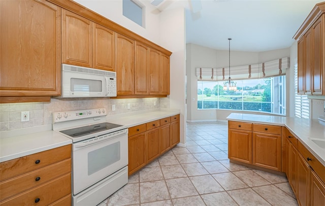 kitchen with tasteful backsplash, white appliances, light countertops, and lofted ceiling