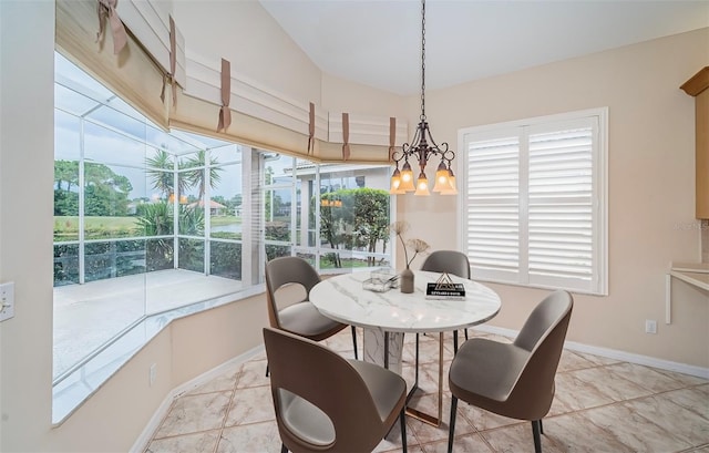 dining space with an inviting chandelier and baseboards