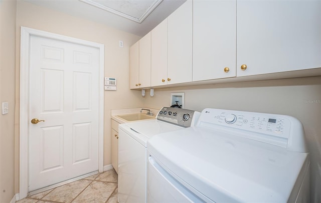 laundry room with cabinet space, washer and dryer, and a sink