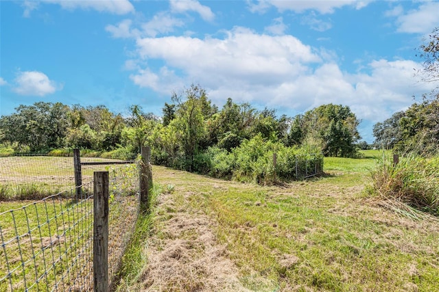 view of yard featuring a rural view and fence