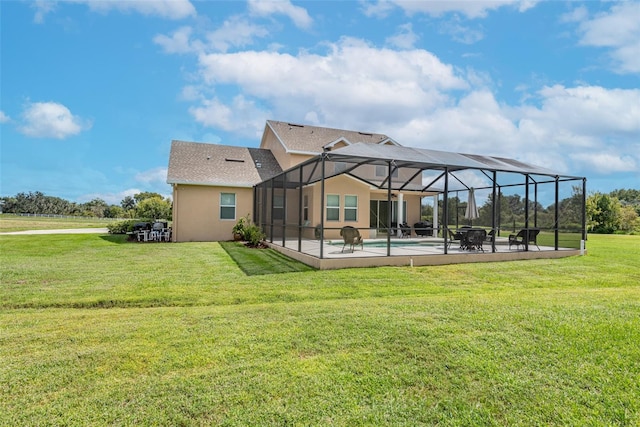 back of house featuring an outdoor pool, stucco siding, a patio area, a lawn, and a lanai