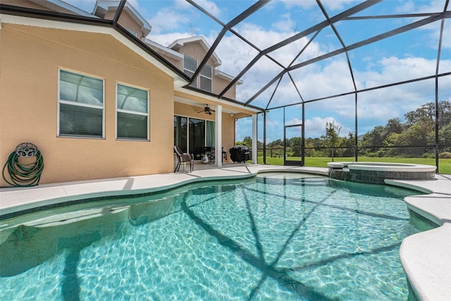 view of swimming pool featuring a patio area, a lanai, a pool with connected hot tub, and ceiling fan