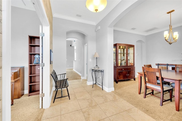 dining room with crown molding, light tile patterned floors, arched walkways, light carpet, and an inviting chandelier