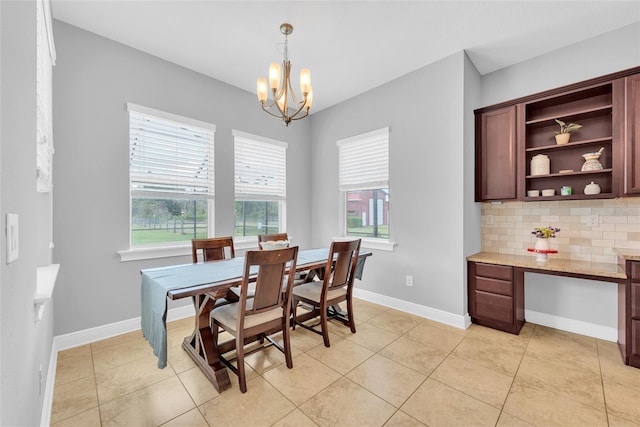 dining room with baseboards, an inviting chandelier, and light tile patterned floors
